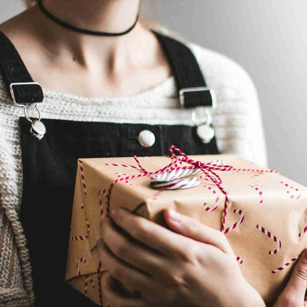 Photo of sad girl with holiday gift by Kira auf der Heide on Unsplash