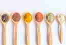 Wooden spoons full of colorful spices and seed depicting micronutrients for nutritional psychiatry
