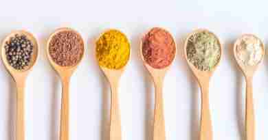 Wooden spoons full of colorful spices and seed depicting micronutrients for nutritional psychiatry
