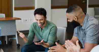A group of people sitting in a circle laughing and listening to shared stories.