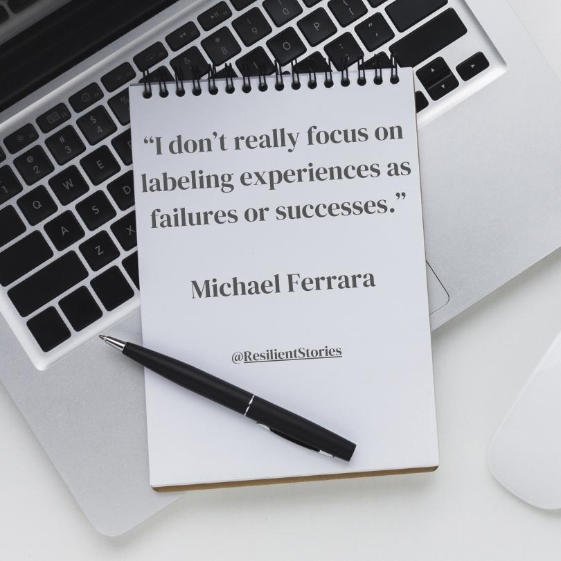 A quote from Michael Ferrara about career challenges that reads, "I don't really focus on labeling experiences as failures or successes." The quote appears on an open notepad that is sitting on top of a lap top keyboard.