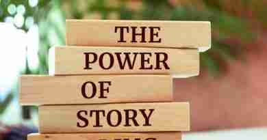 A stack of wooden blocks, with each block containing a word, spelling out the phrase "the power of story telling"