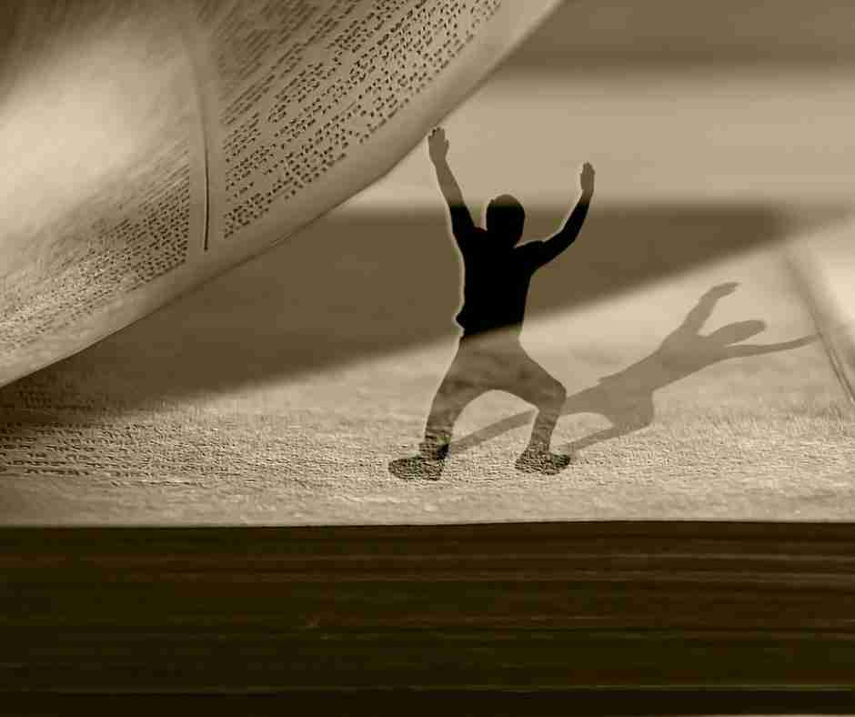 Untitled design (16) - Resilient Stories AI-generated image of a miniature man's silhouette trying to hold up the page of a book