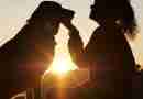 Photo of woman and dog silhouetted against setting sun. Photo by lokalsportessen from Pixabay