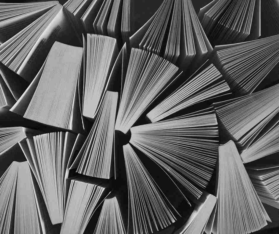 Top view of white books on black background