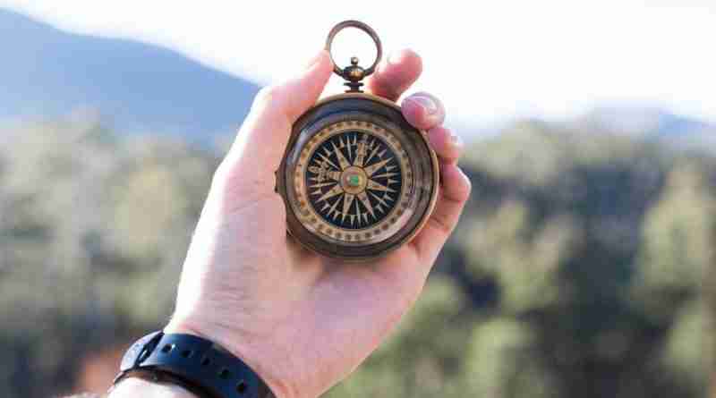 Photo of a hand holding up a compass. Image by Pexels from Pixabay