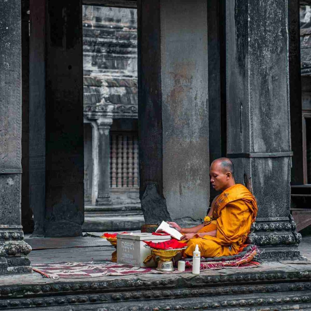 Image of buddhist monk practicing mantra meditation outside temple by theminjukim from Pixabay
