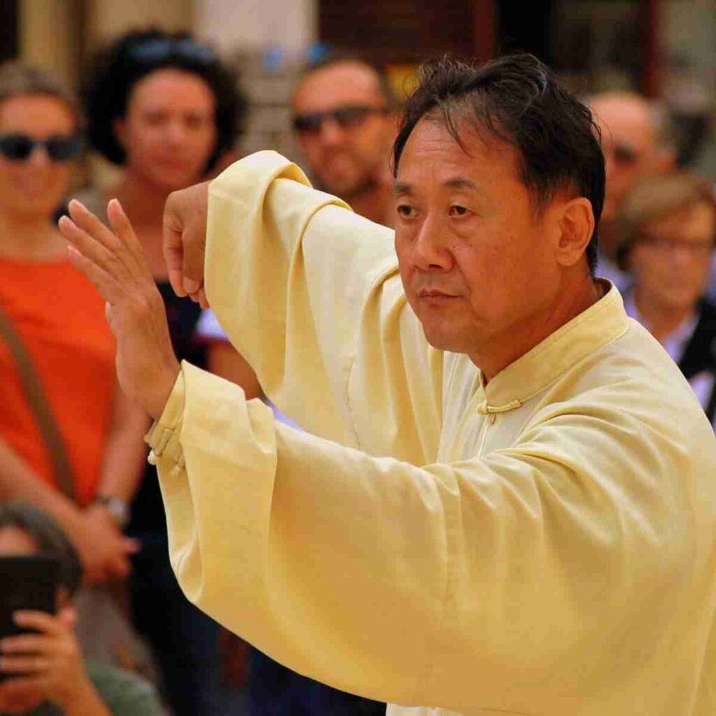 Photo of Asian man practicing tai chi. Photo by Gianni Crestani from Pixabay