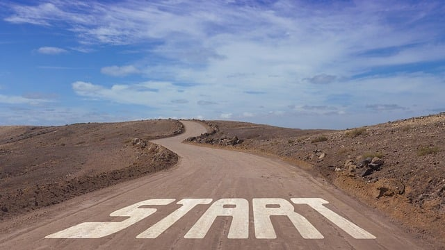 Photo of a dusty road in the desert with large words over the road that read "START"