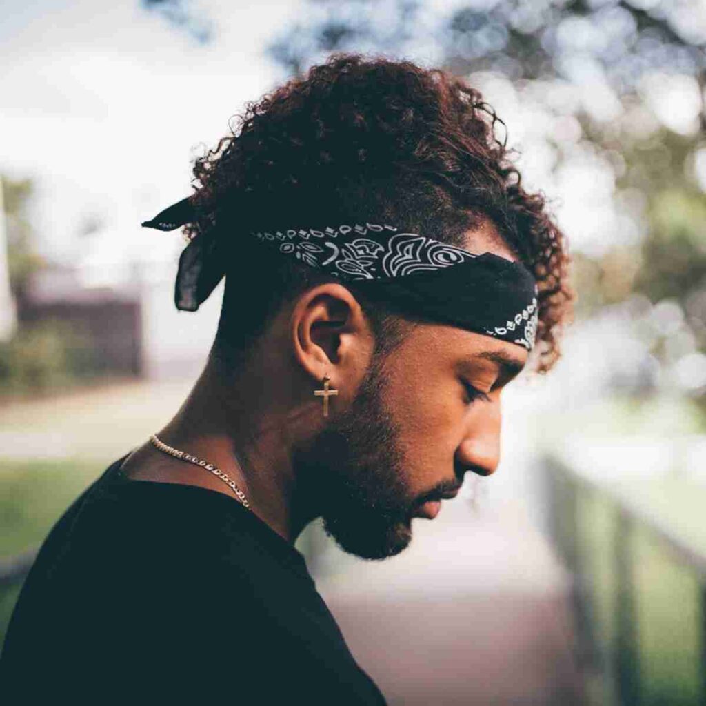 Photo of young man with head down looking sad. Image by Matty Rogers from Pixabay