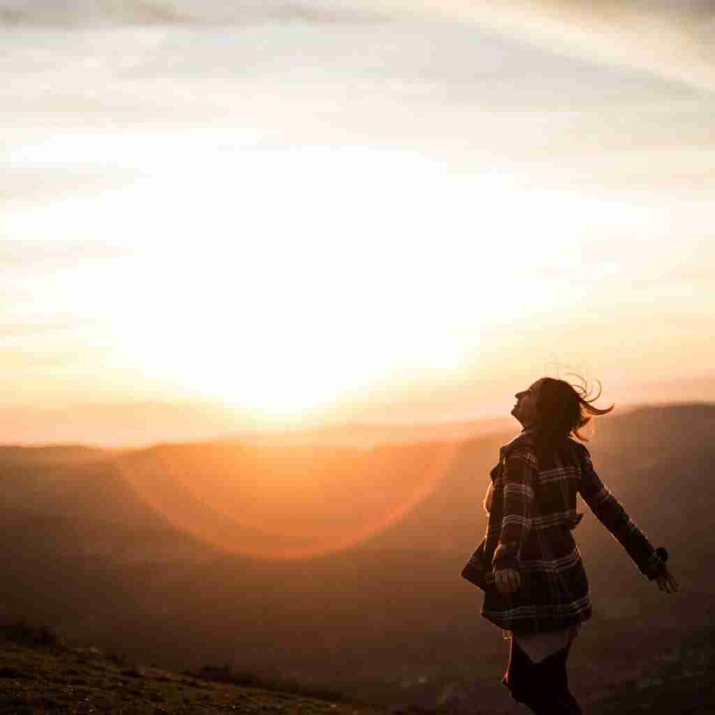 Untitled design (36) - Resilient Stories Woman walking in sunshine enjoying herself having fun