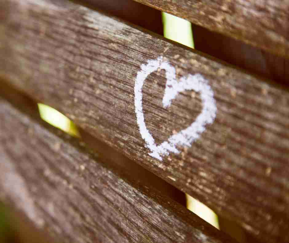 Untitled design (63) - Resilient Stories Photo of a heart drawn in chalk on wooden bench