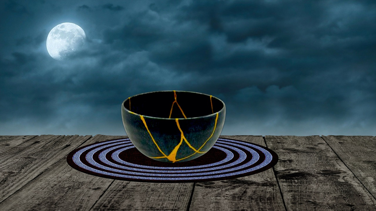 Kintsugi repaired bowl sitting on table under cloud, full moon sky 