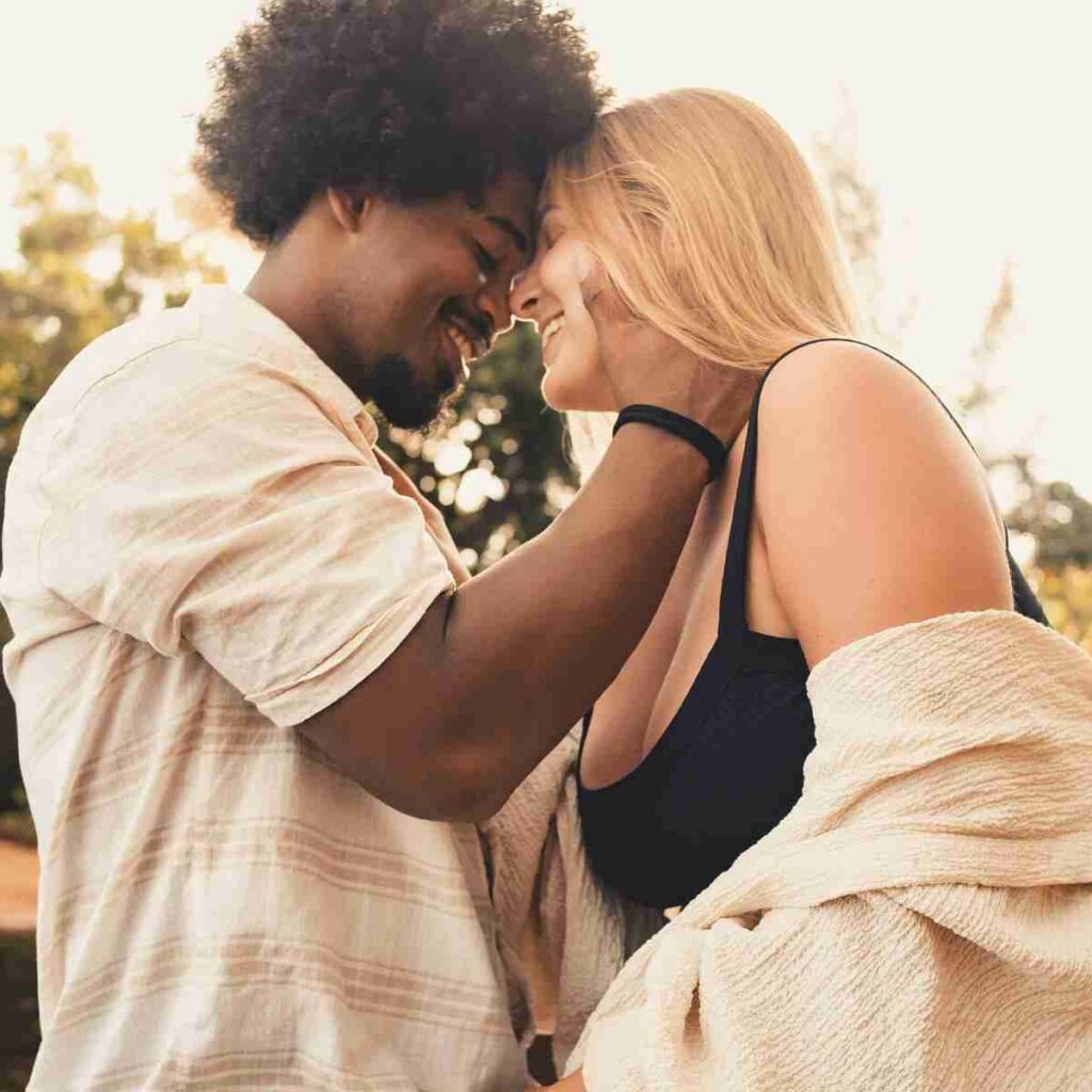 Photo of interracial couple embracing, happy in love. Photo by Letícia Pelissari on Unsplash