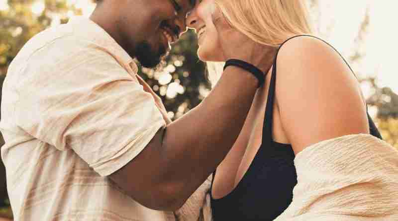 Photo of interracial couple embracing, happy in love. Photo by Letícia Pelissari on Unsplash