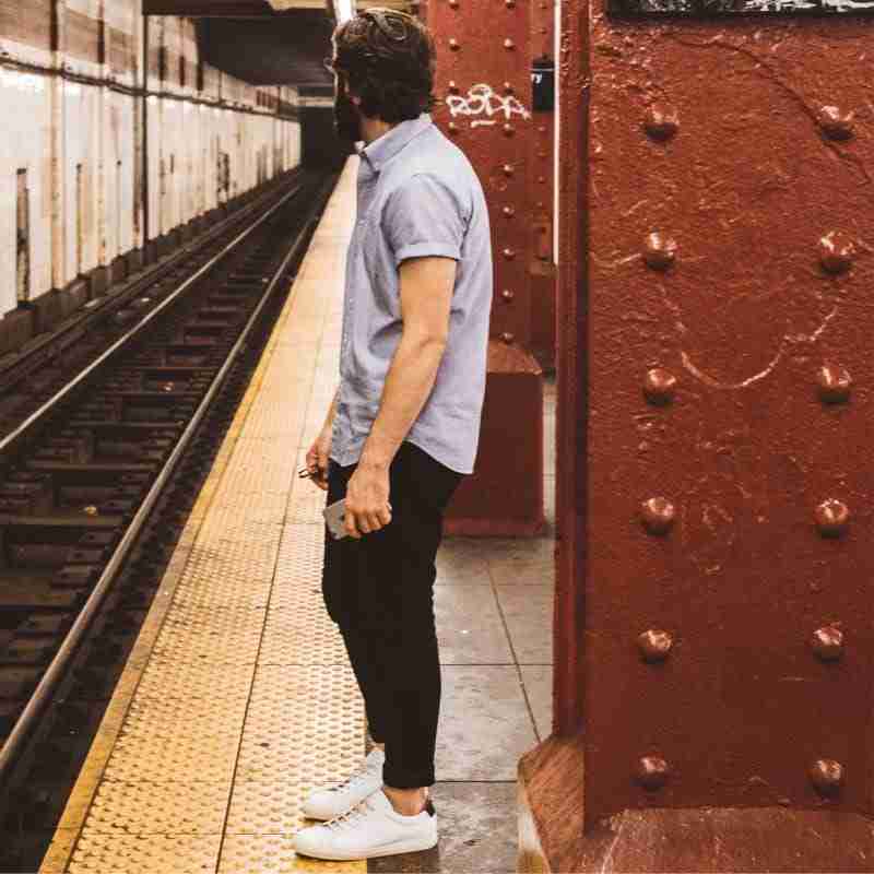 Man waiting patiently for subway train
