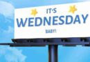 Billboard set against bright blue sky that reads "It's Wednesday Baby!"