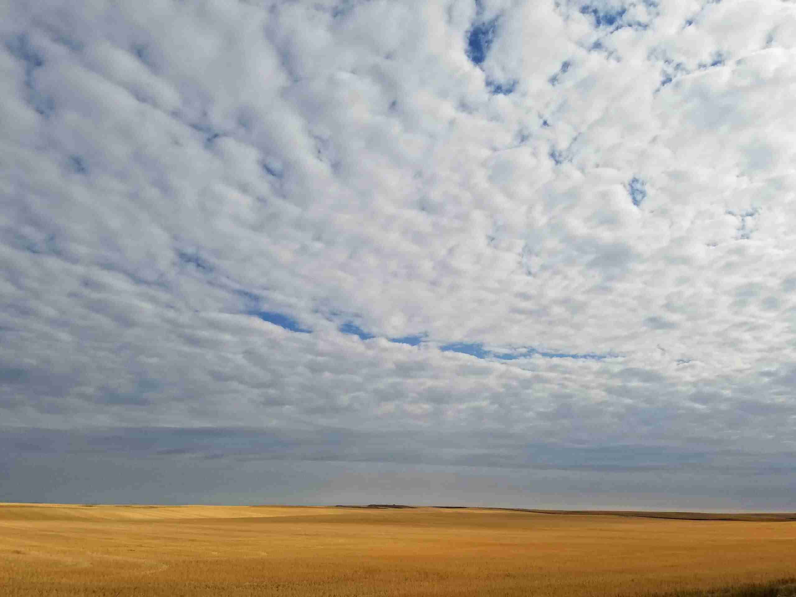 The vast cloudy sky over the prairie.