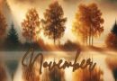 An AI generated image of trees by a placid lake. The trees have orange and red leaves, the sky is bathed in orange and gold. And the word November is printed on the lake.