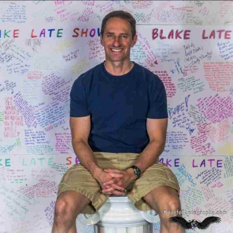 A photo of Ron, a male rape victim, in front of many of the boards signed by strangers who were moved by his story.