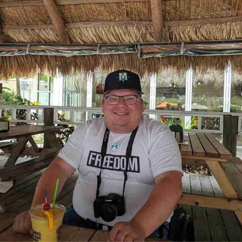 Mitch enjoying an adult beverage on a tropical family vacation.
