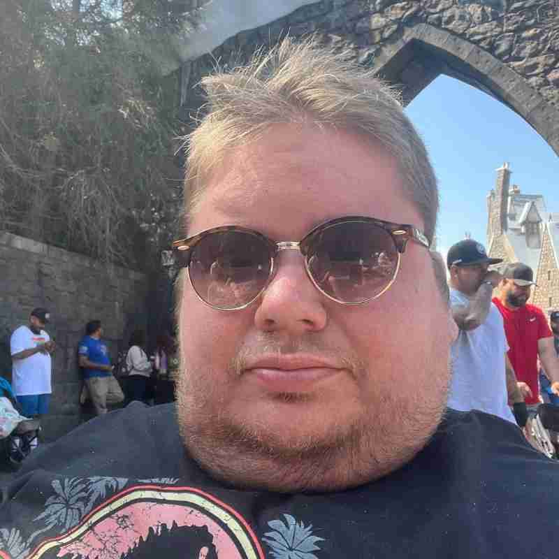 An image of Mitch at a theme park on vacation.