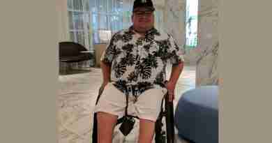 Mitch Bohn in his wheelchair in hotel room