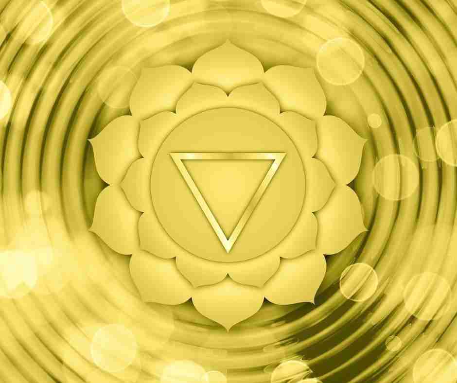 Yellow ripples surround the symbol of the solar plexus chakra