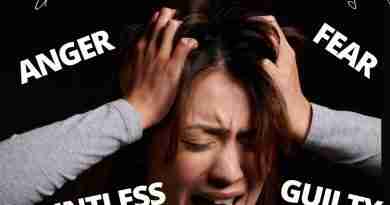A woman clutches at her head during an anxiety attack while emotion words like anger, fear, pointless, guilty, sad and shame surround her.