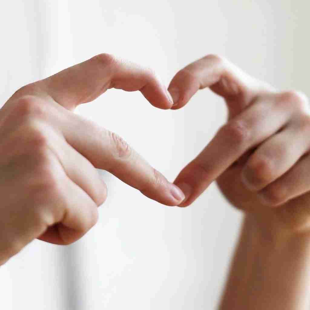 Hands making a "heart" with the fingers.