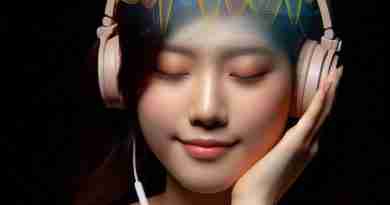 AI-generated image of Asian girl listening to headphones with eyes closed and colorful glowing representation of sound waves going through her head