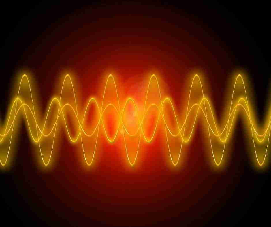 Glowing yellow/orange representation of sound waves on a back background
