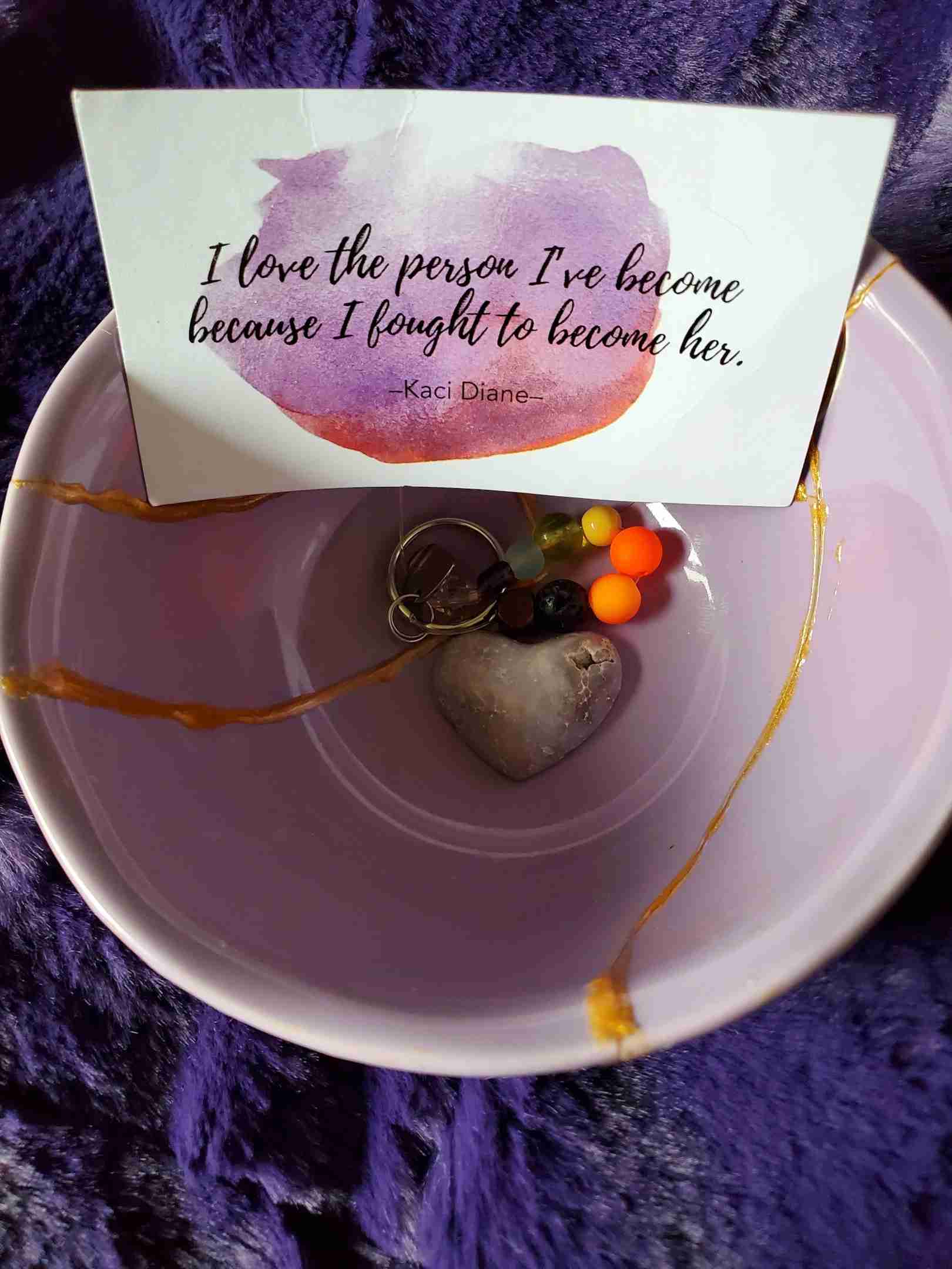 "I love the person I've become because I fought to become her." The quote by Kaci Diane is inside a kintsugi bowl made by Dr. Donna Bulatowicz and used in her article about how Kintsugi demonstrates self-love and acceptance.