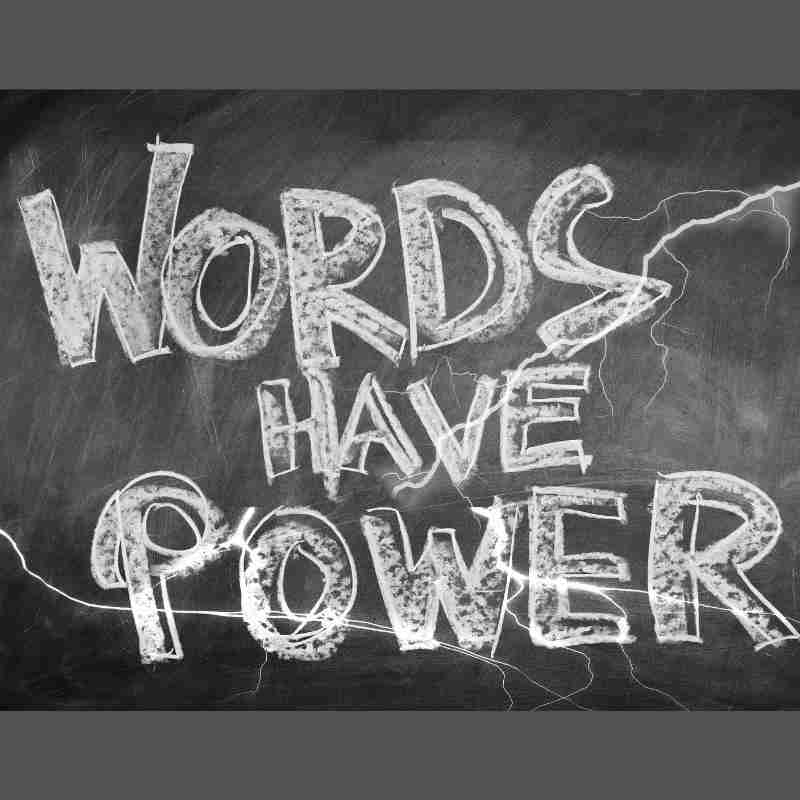 The words, "Words Have Power" are written on a chalkboard with strikes of lightning drawn on the chalkboard.