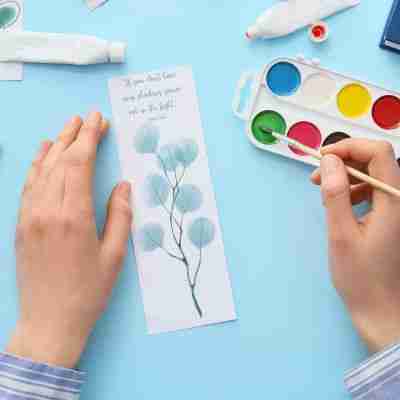 10 - Resilient Stories Photo of two hand creating a handmade quote bookmark.
