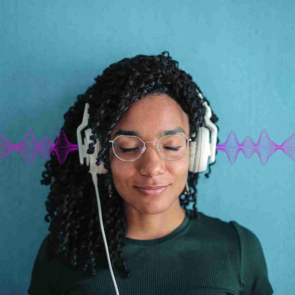 Woman with eyes closed and headphones on, looking tranquil listening to 396 Hz frequency
