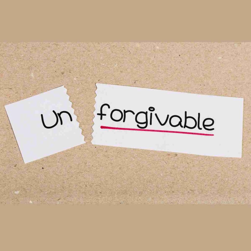 The word "unforgivable" is written on a slip of paper with the word un torn off. Choosing to forgive or not forgive someone is a personal choice.