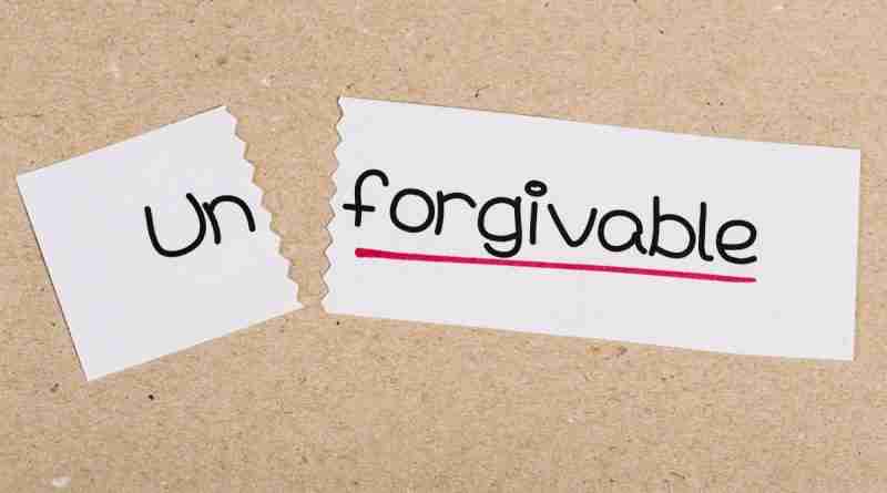 The word "unforgivable" is written on a slip of paper with the word un torn off. Choosing to forgive or not forgive someone is a personal choice.