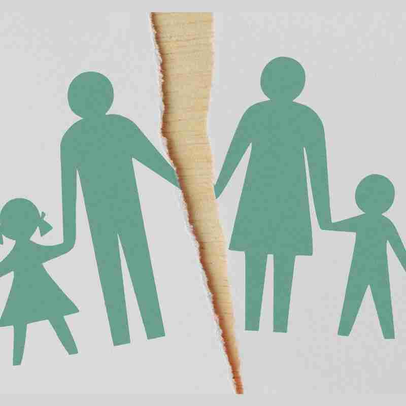 A stick figure family on a piece of paper with a tear down the center, indicating the parents got divorced.