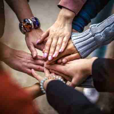 Photo of a circle of women's hands, showing unity and birth mom support