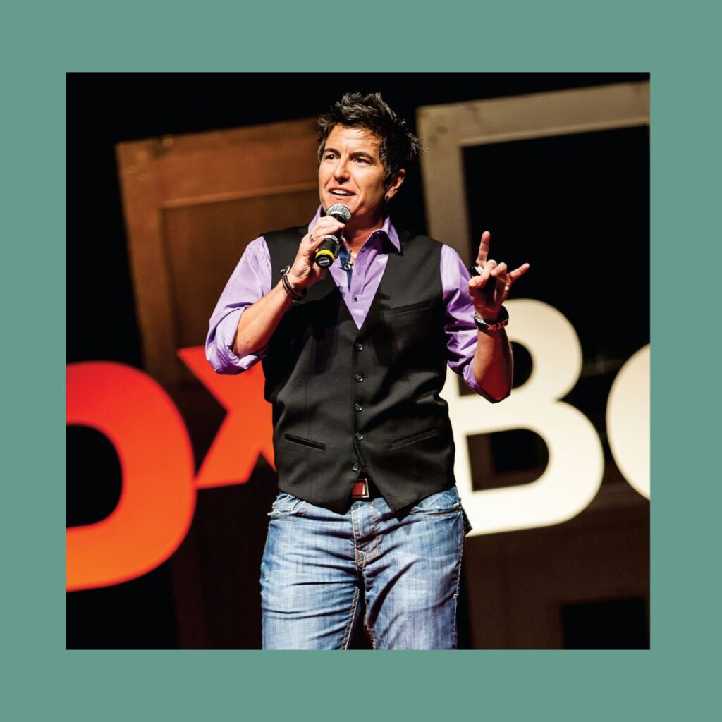 A photo of Ash Beckham on the TEDx Boulder stage.