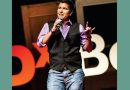 A photo of Ash Beckham on the TEDx Boulder stage.