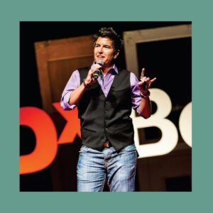 A photo of Ash Beckham on the TEDx Boulder stage.
