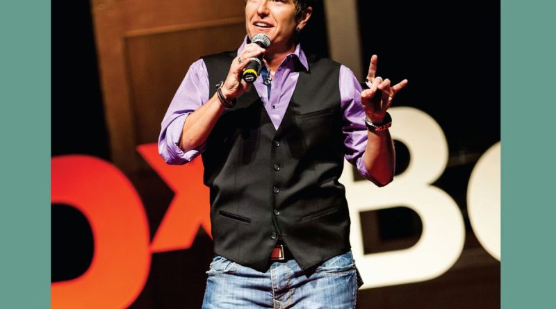 A photo of Ash Beckham on the TEDx Boulder stage.