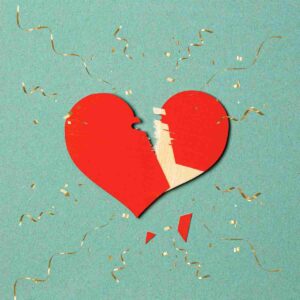 A broken heart with exploding confetti around it signifying someone having a divorce party to commemorate the end of their marriage.