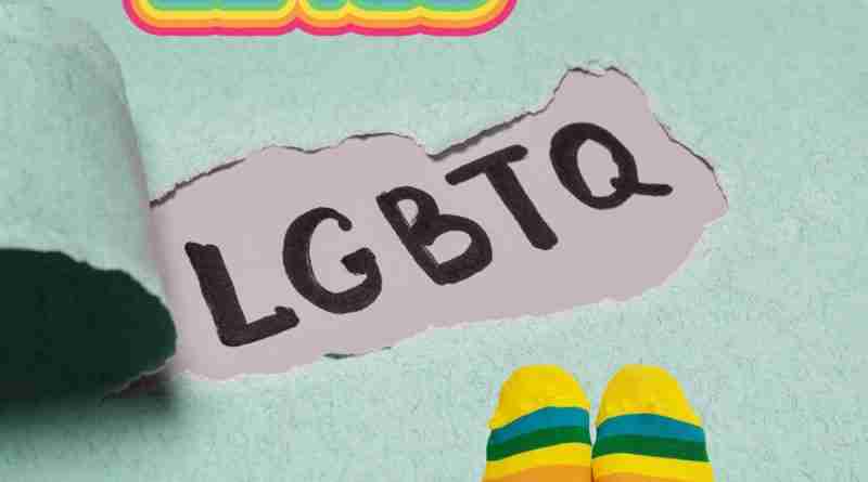 A green background with the words "Be You" and "LGBTQ" on it. There are a pair of feet wearing rainbow socks in the corner.