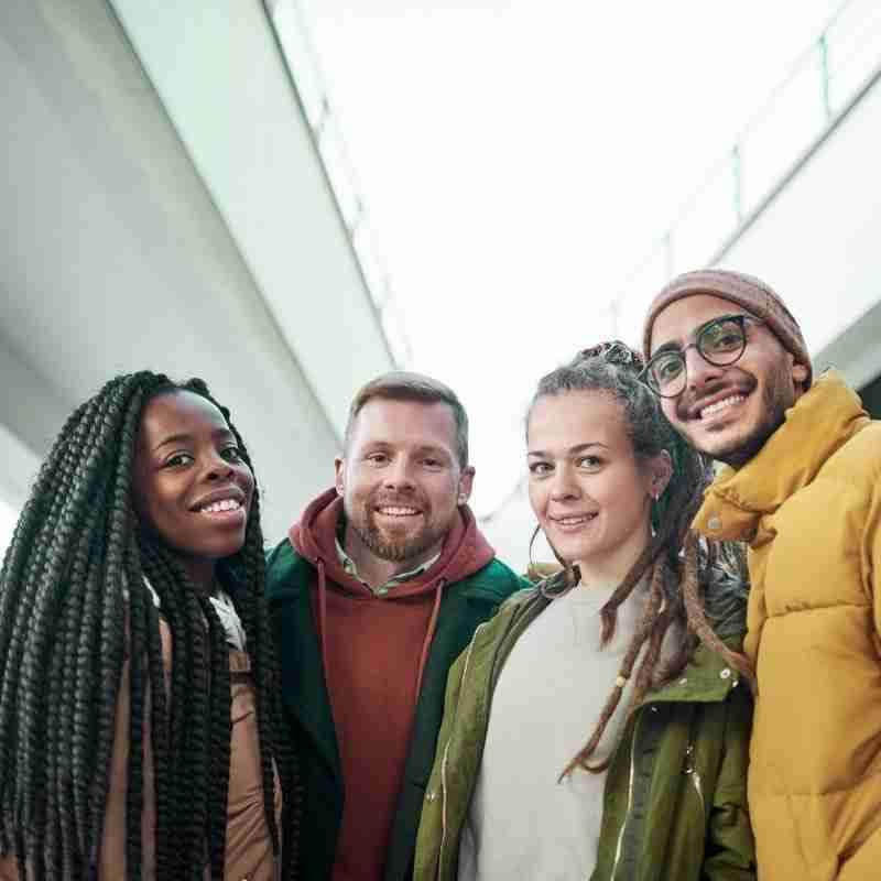 A group of diverse people smiling.