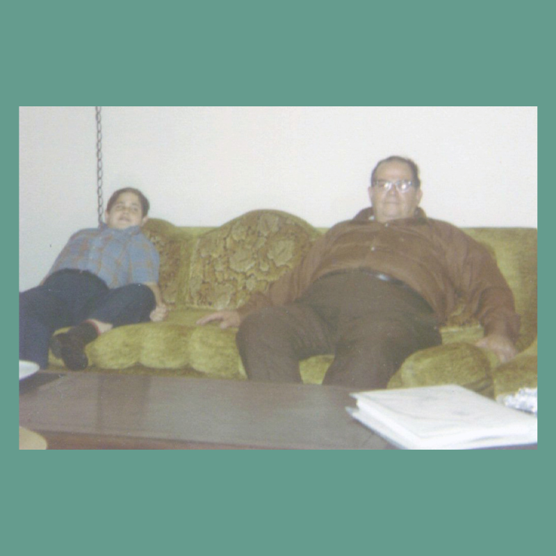 A photo of Stanley Bronstein and his father on the couch.