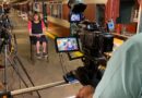 A photo of Bernie being interviewed after transitioning from the male voice behind the NYC subway.