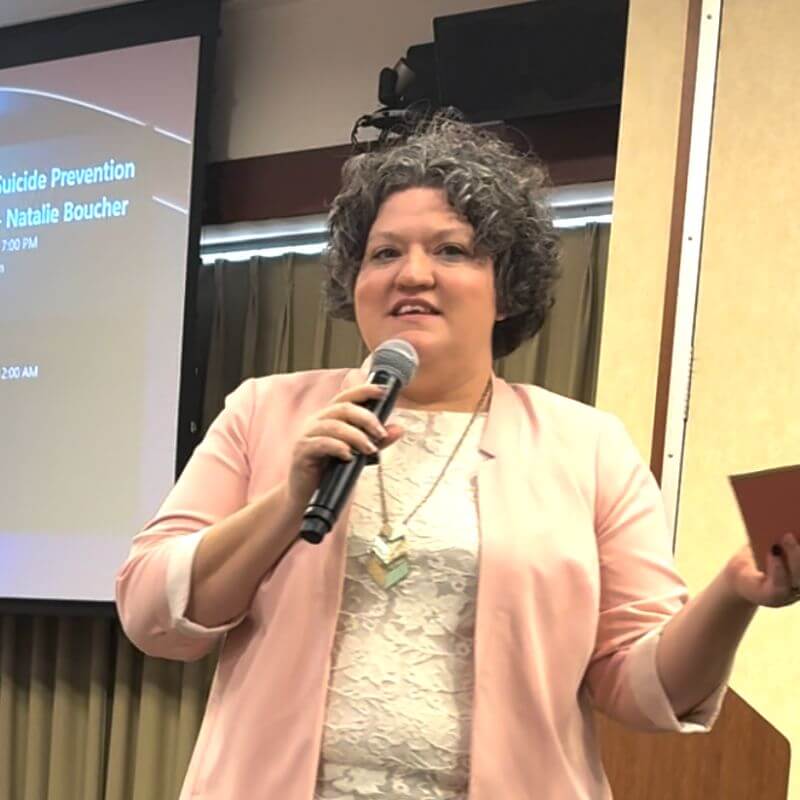 A photo of Danielle giving her keynote about connecting through stories as a means of suicide prevention.